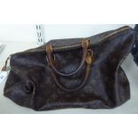 A Louis Vuitton leather holdall/handbag with a zipped opening,