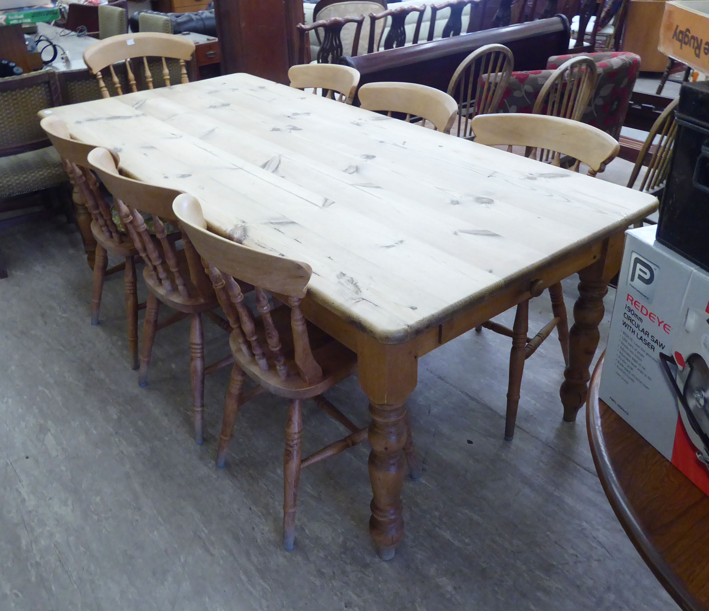 A modern honey coloured pine farmhouse kitchen table with a scrubbed, planked top,