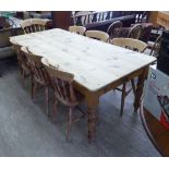 A modern honey coloured pine farmhouse kitchen table with a scrubbed, planked top,