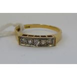 An 18ct gold five stone diamond ring 11