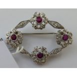 An 18ct white gold brooch of floral design,