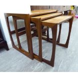 A nesting set of three G-Plan teak occasional tables, raised on rounded,