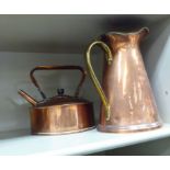 An early 20thC copper and brass ewer of tapered form with a loop handle,