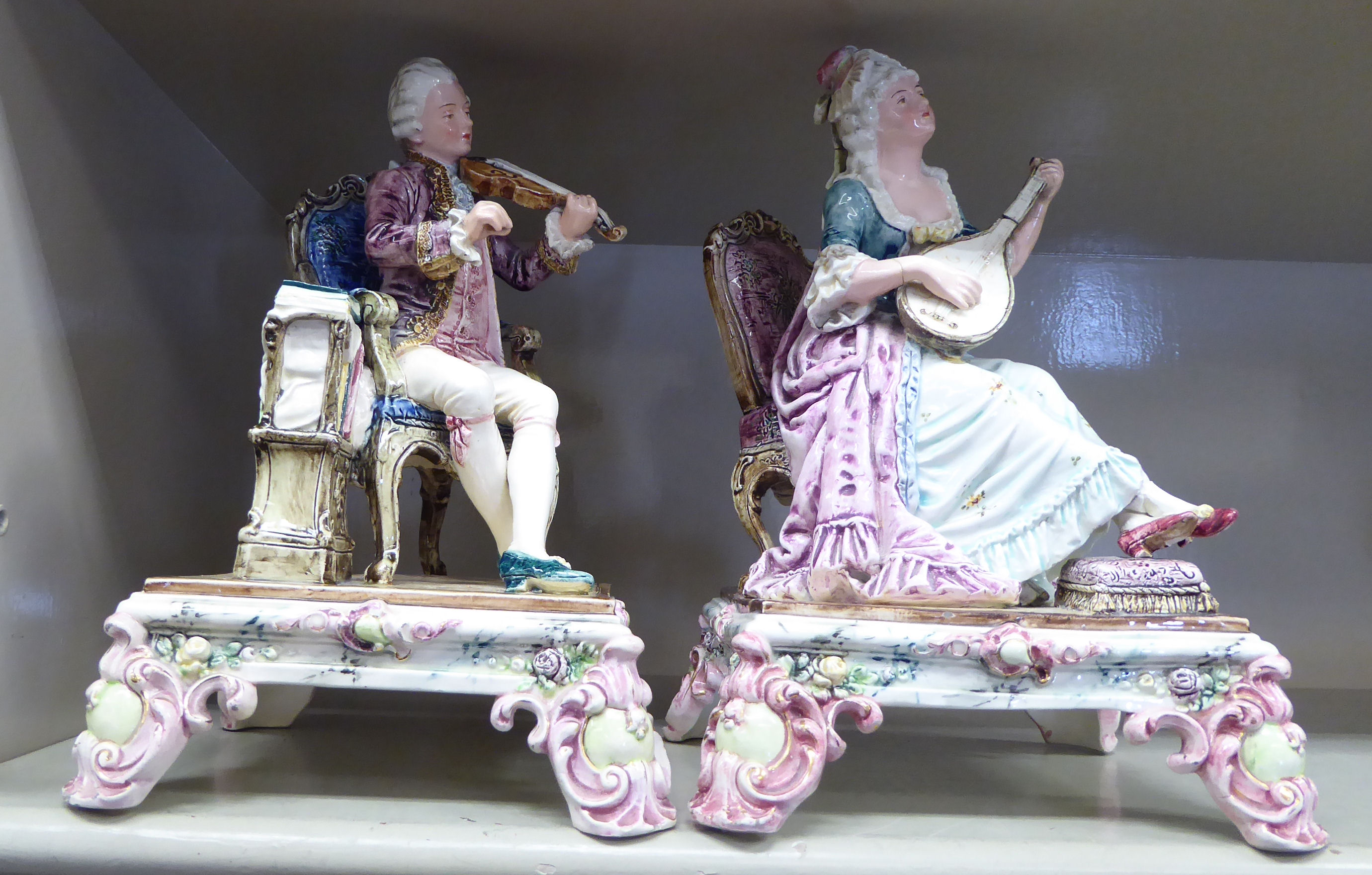 Two similar early 20thC European porcelain figures, a man and woman wearing period costume,