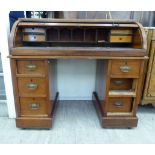 A late Victorian mahogany twin pedestal desk with a rising tambour cover,