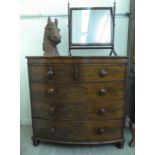 An early 19thC mahogany five drawer bow front dressing chest,