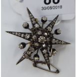 A bi-coloured metal star design and diamond set brooch 11