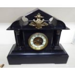 A 1930s black slate cased mantel clock;