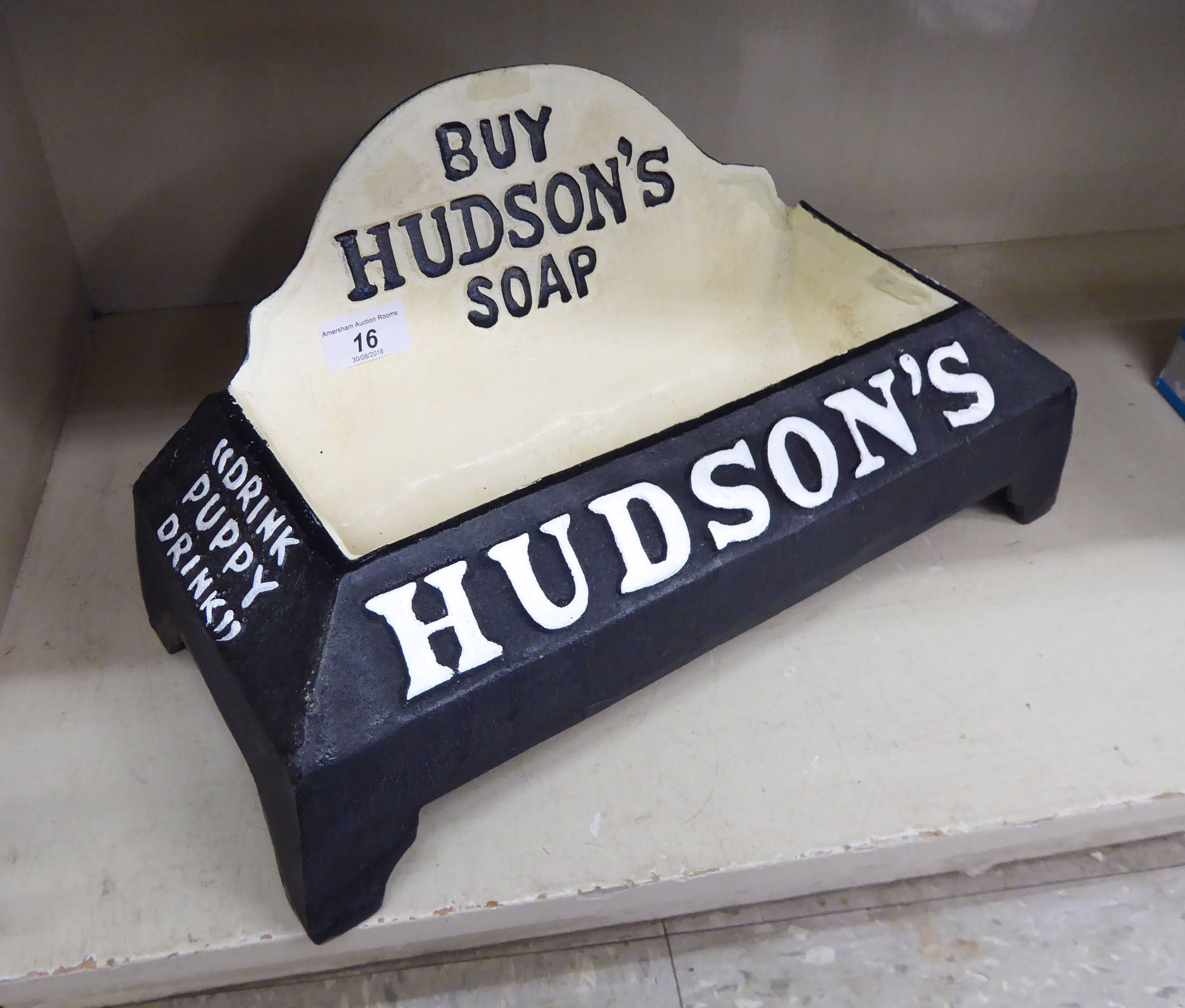 A cast iron dog's bowl with advertising logos for 'Hudson's Soap' 15''w OS2