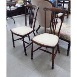 A pair of mid/late 20thC stained beech bar and spindle back chairs,