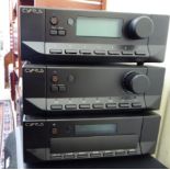 A Cyrus stereo system, comprising an amp, tuner and CD player with instructions,