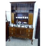 An early 19thC style stained oak dresser,
