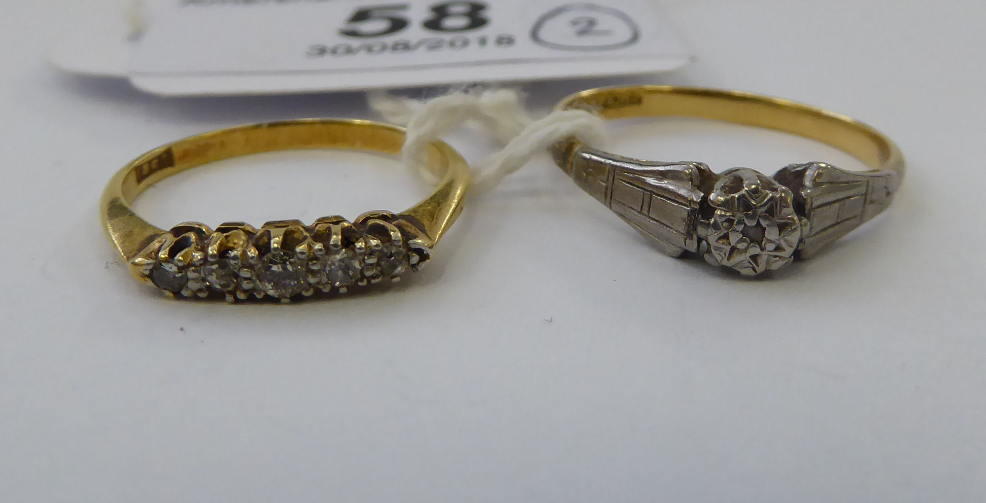 Two dissimilar 18ct gold and diamond set rings 11