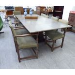 An early 20thC and later limed oak, draw leaf dining table, raised on cut-out,