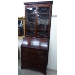 A mid 20thC mahogany bureau bookcase with two astragal glazed doors, a fall flap and four drawers,