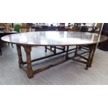 A modern Jacobean style oak wake design gateleg dining table, the top with fall-flaps,