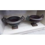 A pair of Victorian style cast iron, twin handled, campana design terrace urns 10''h 11.