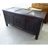 A late 18thC stained oak coffer with a hinged lid and straight sides, over a tri-panelled front,