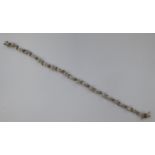 A 9ct white gold diamond set multi-link bracelet 11