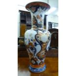 A Kaiser china vase with a flared lip and tapered, bulbous body, decorated with exotic birds,