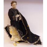 A late 19thC Continental doll with a porcelain head, lower arms and feet and painted features,