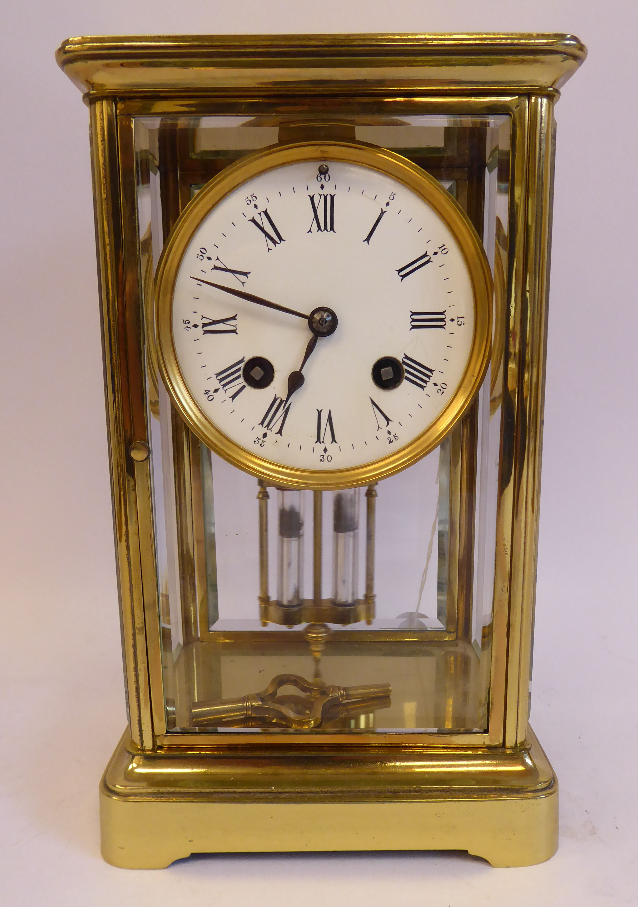 An early 20thC lacquered brass cased, four glass mantel clock,