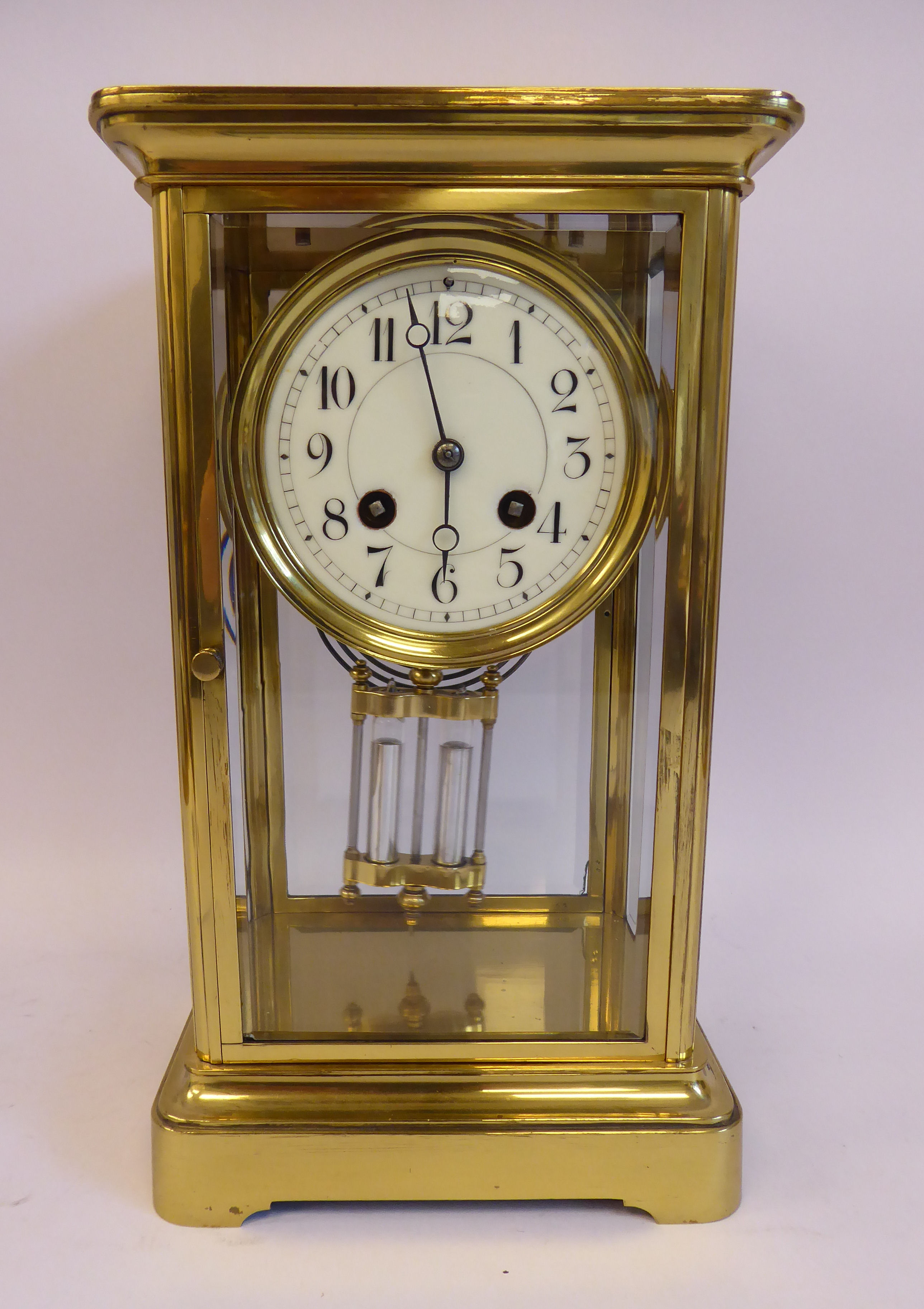 An early 20thC lacquered brass cased, four glass mantel clock,