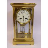 An early 20thC lacquered brass cased, four glass mantel clock,