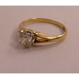 A gold coloured metal claw set diamond solitaire ring