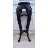 An early 20thC Chinese profusely carved and stained hardwood jardiniere stand,