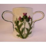 A Wemyss cream coloured pottery triple handled, straight sided cup,