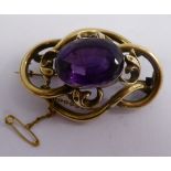 A yellow metal brooch,