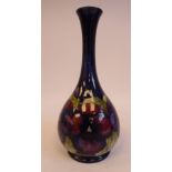 A Moorcroft pottery bottle vase of bulbous form with a long, narrow, waisted neck and flared rim,