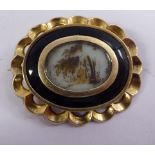 An 'antique' yellow metal and black enamel,