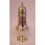 A Georgian style silver caster of pedestal vase design with a domed,