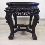 An early 20thC Chinese profusely carved and stained hardwood stool design jardiniere stand,