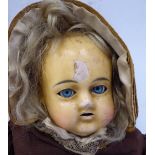 A late 19thC wax head doll with fixed glass eyes,