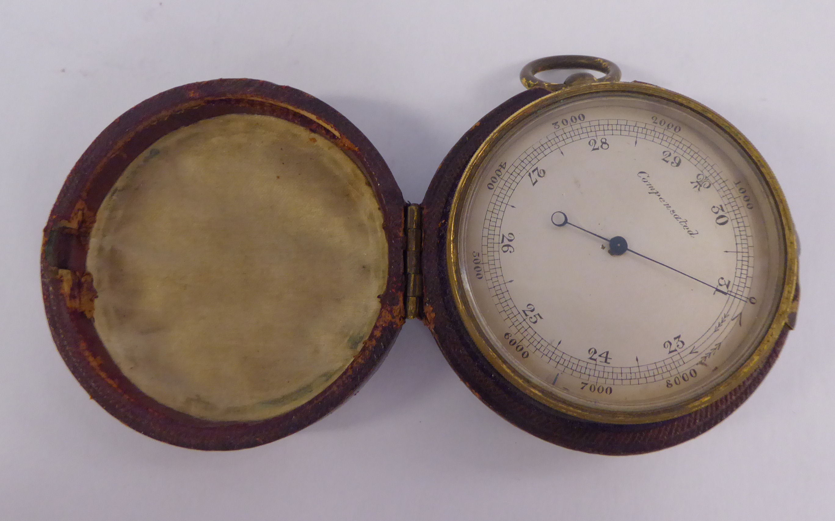 A late 19thC lacquered gilt metal drum cased pocket barometer with a silvered steel dial,