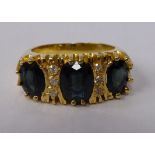 An 18ct gold claw set nine stone sapphire and diamond ring