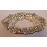 A silver coloured metal dish with a wide, flared,
