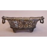 A late 19th/early 20thC Thai silver coloured metal oval basket with decoratively pierced, engraved,