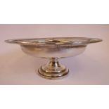 A silver coloured metal tazza with a shallow bowl, a decoratively pierced,