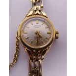 A lady's Rotary 9ct gold round cased wristwatch, on a gatelink bracelet,