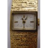 A lady's Hamilton 9ct gold cased bracelet wristwatch with a wide, flexible, bark effect strap,