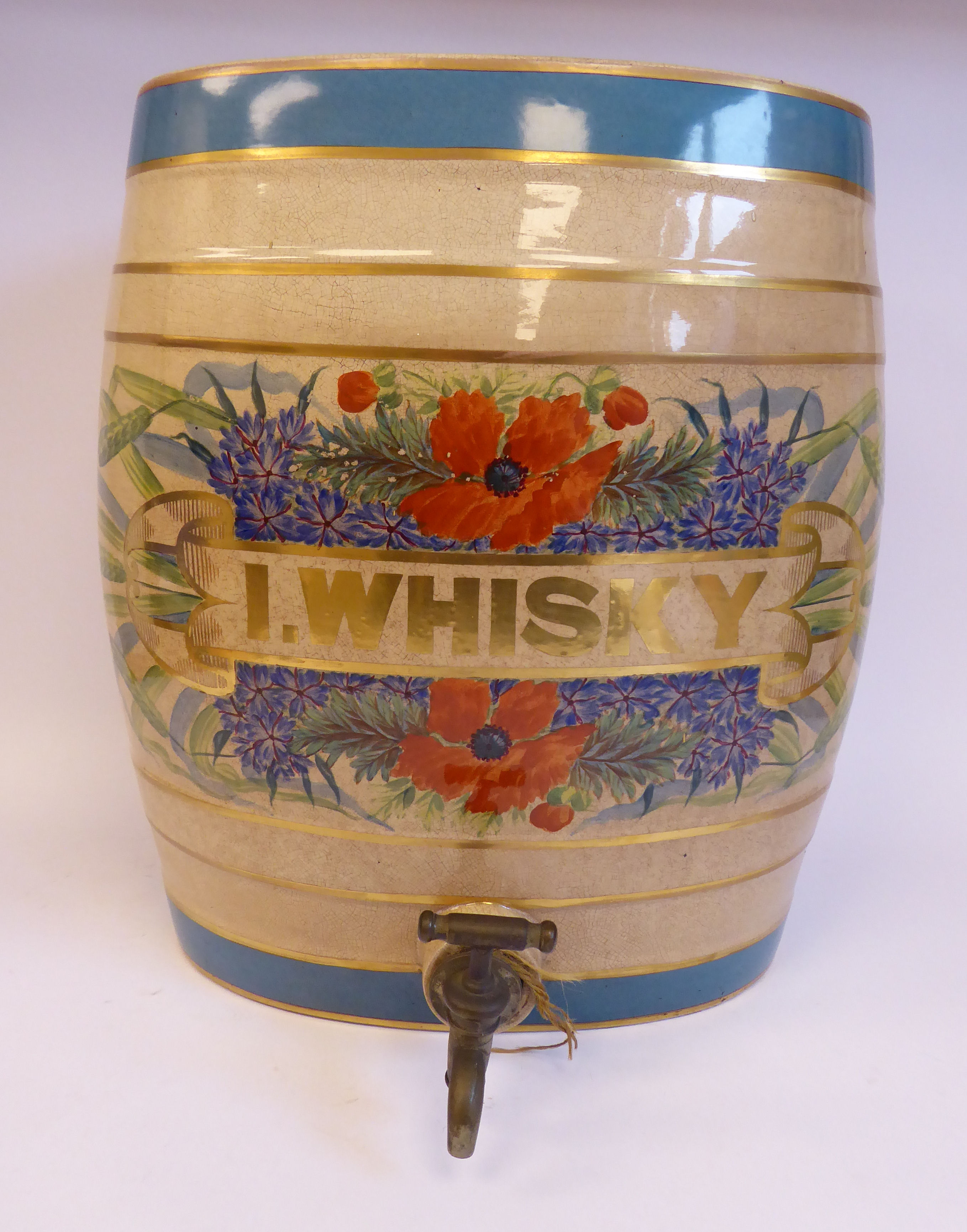 A late 19thC cream coloured pottery, oval barrel design bar room dispenser,