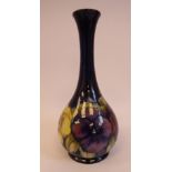 A Moorcroft pottery bottle vase of bulbous form with a long, narrow, waisted neck and flared rim,
