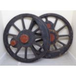 A pair of grey and red painted wooden locomotive wheel patterns,