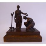 A cast bronze golfing trophy, featuring an allegorical classical scene with two robed women,