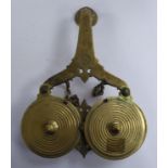 A late 19thC Asian brass traveller's, double bowl receptacle with rotating covers,