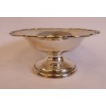 A silver sweet dish with a raised, serpentine outlined, applied wire rim, elevated on a domed,